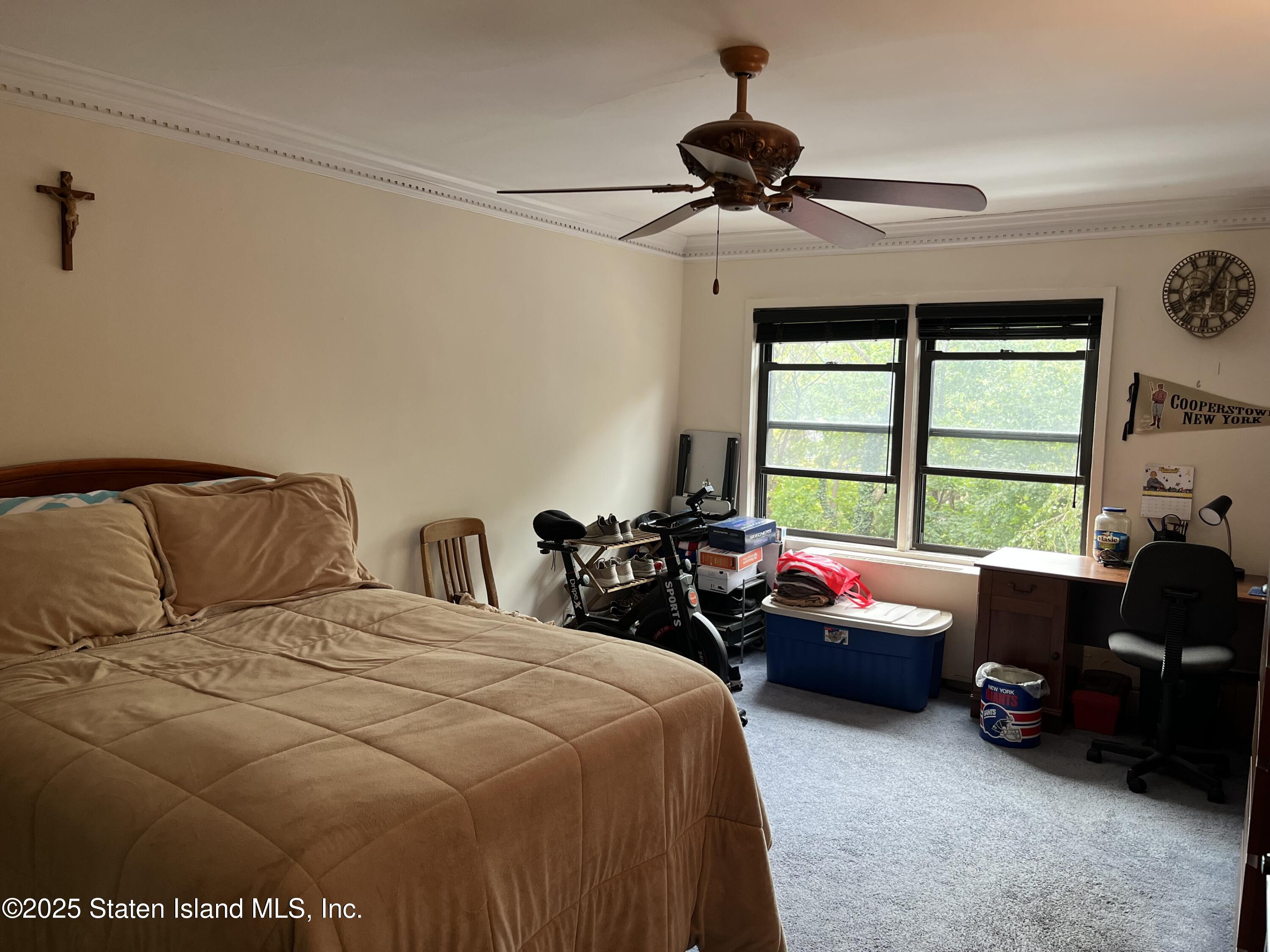 1100 Clove Road, Unit 2N Staten Island, NY 10301 - Photo 16 of 27 a bedroom with bed couch and window