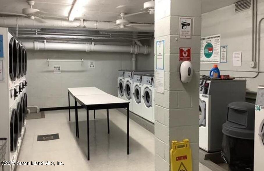 1100 Clove Road, Unit 2N Staten Island, NY 10301 - Photo 20 of 27 a kitchen with refrigerator and table