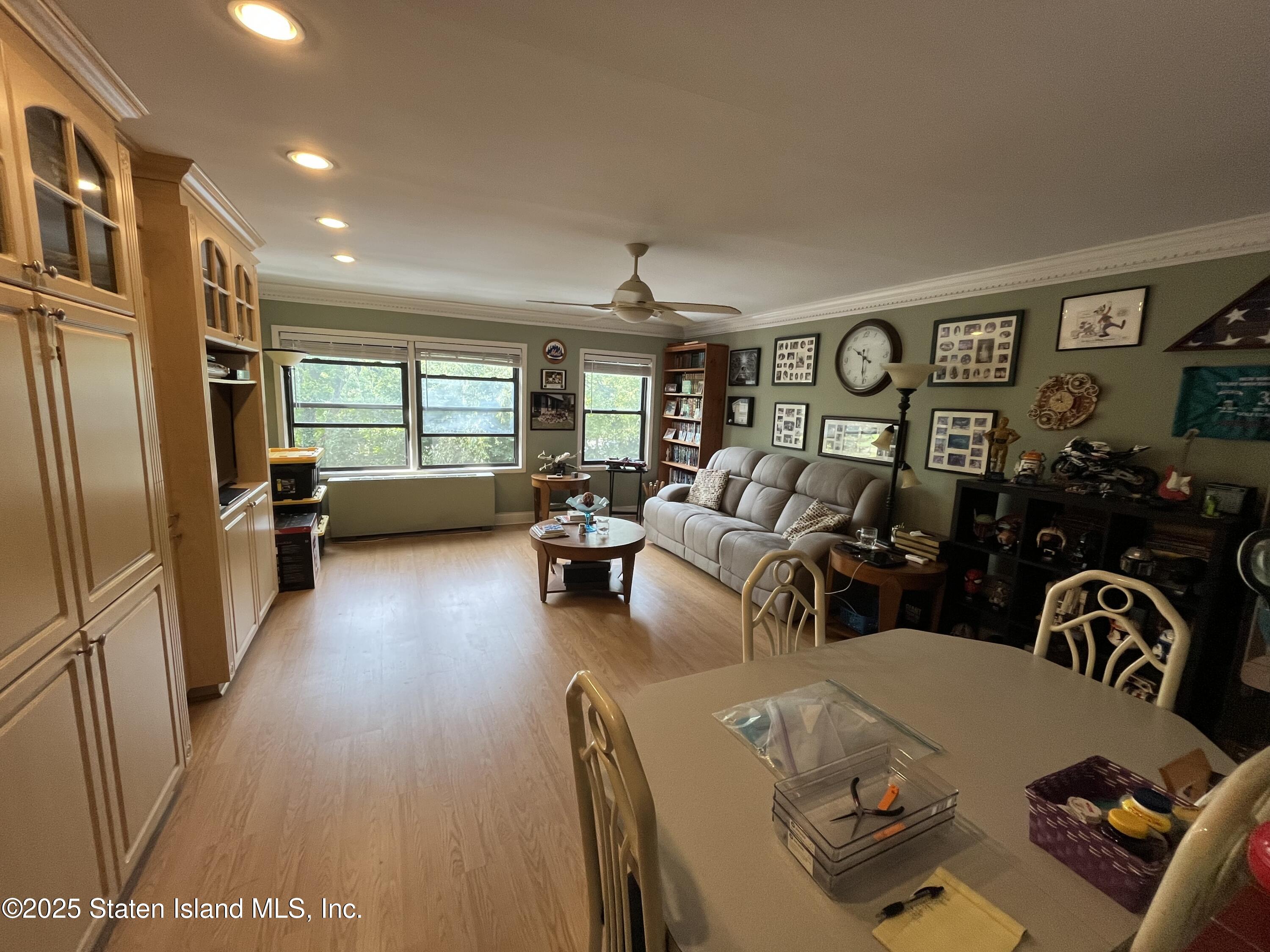 1100 Clove Road, Unit 2N Staten Island, NY 10301 - Photo 8 of 27 a living room with furniture and wooden floor