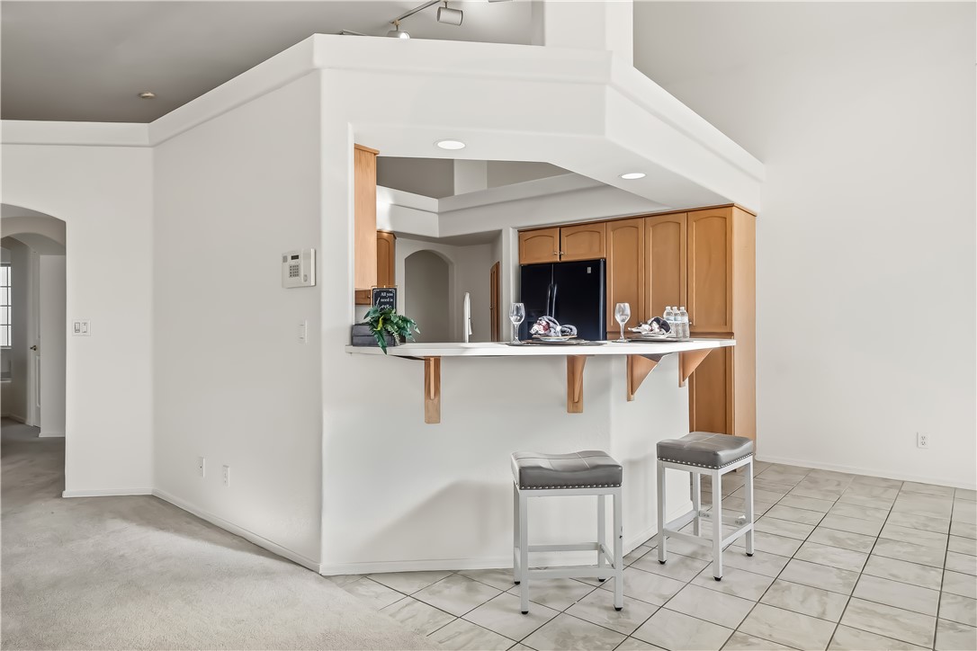 2853 Winchester Road Bullhead City, AZ 86442 - Photo 16 of 40 Kitchen pass-through featuring an extended countertop bar with corbel supports