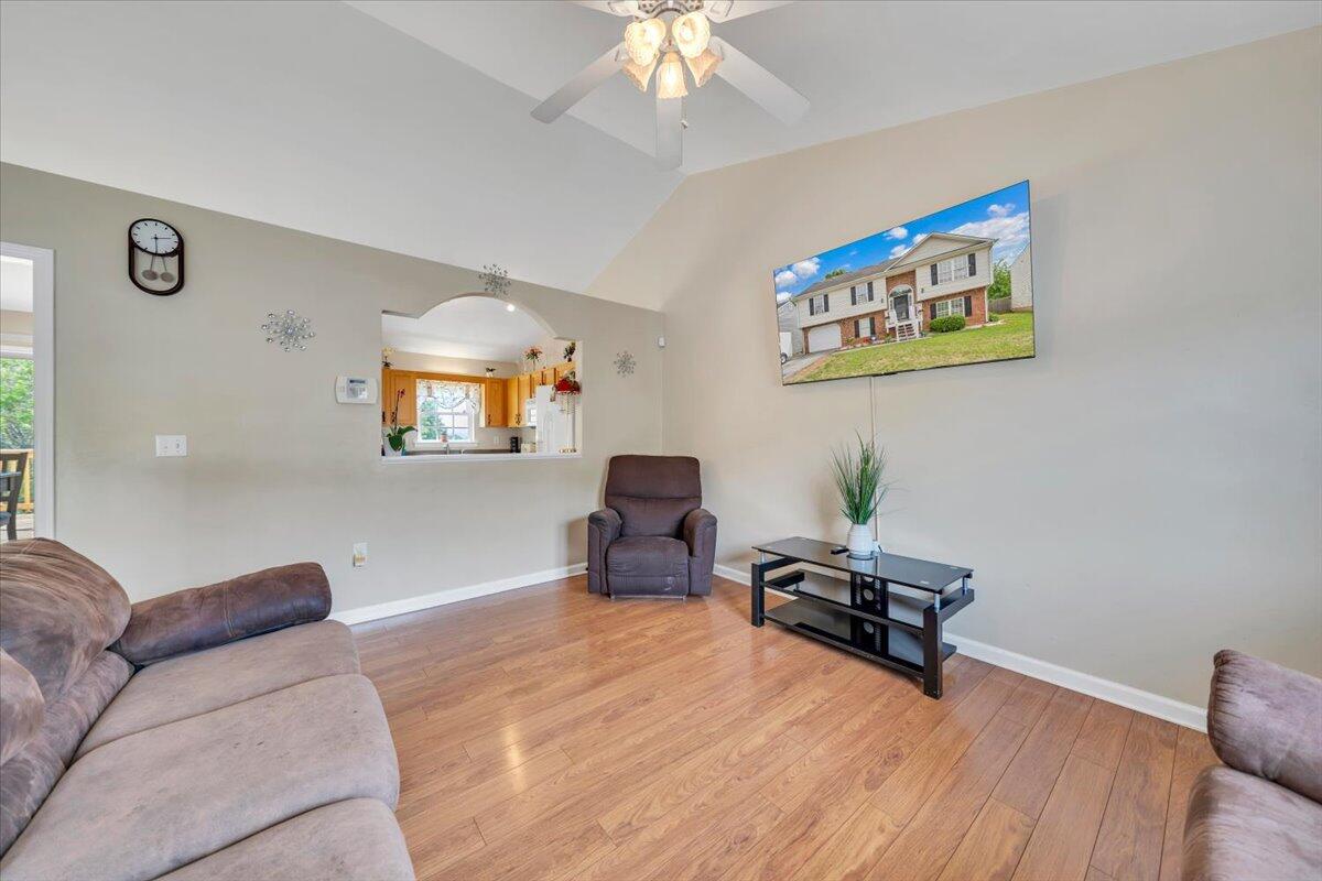 4751 Westvale Road Northeast Roanoke, VA 24019 - Photo 6 of 30 a living room with furniture and a chandelier