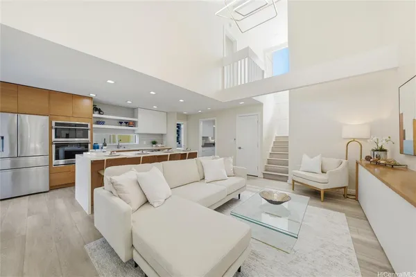 a living room with furniture and kitchen view