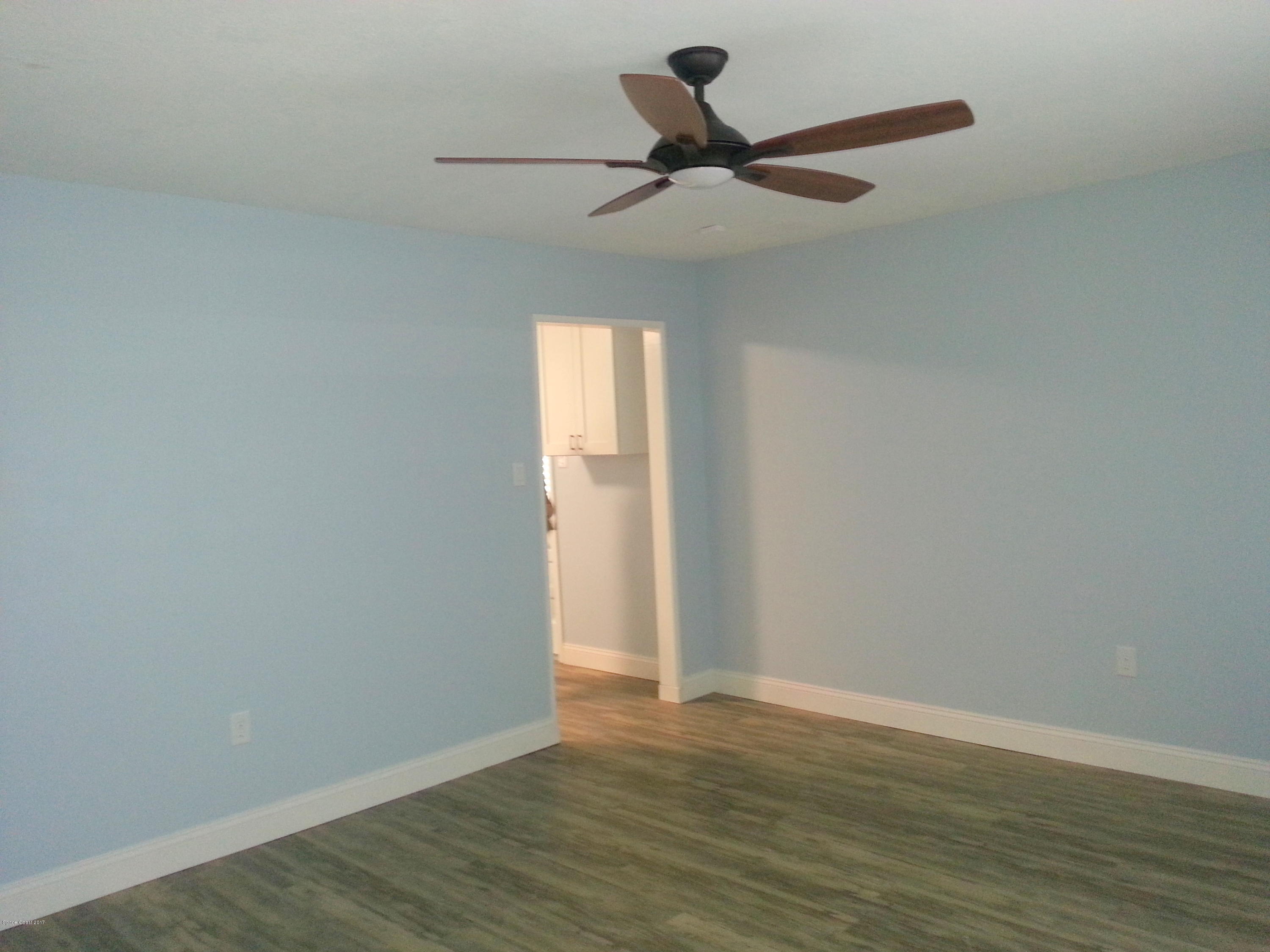 1020 Cherokee Road Southeast Palm Bay, FL 32909 - Photo 14 of 28 Great Room New Floors 5" Baseboards