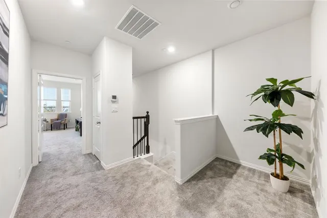 a spacious bedroom with a bed a couch and a large window