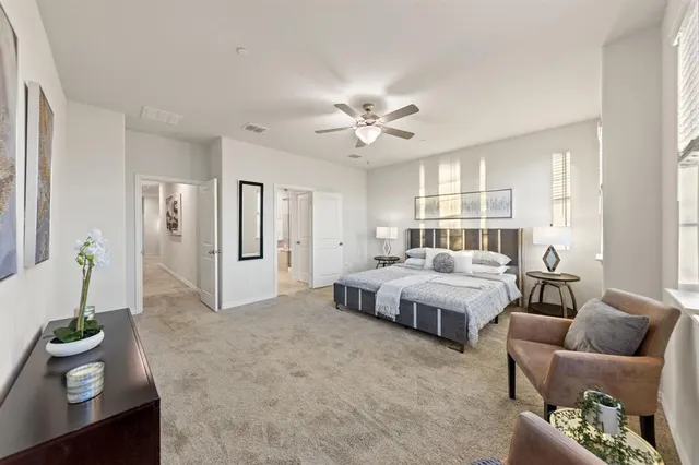 a spacious bedroom with a bed and furniture