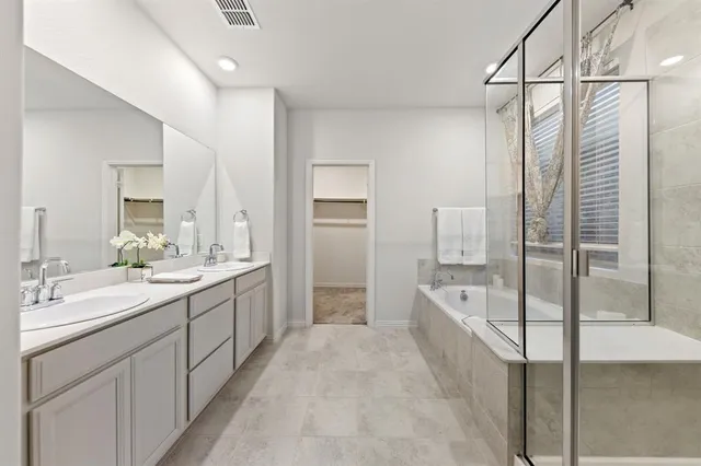 a bathroom with a double vanity sink mirror and shower