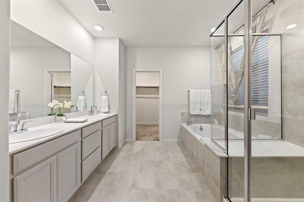 7505 Sunset Boulevard Rowlett, TX 75088 - Photo 17 of 33 a large bathroom with a double vanity sink a large mirror and shower