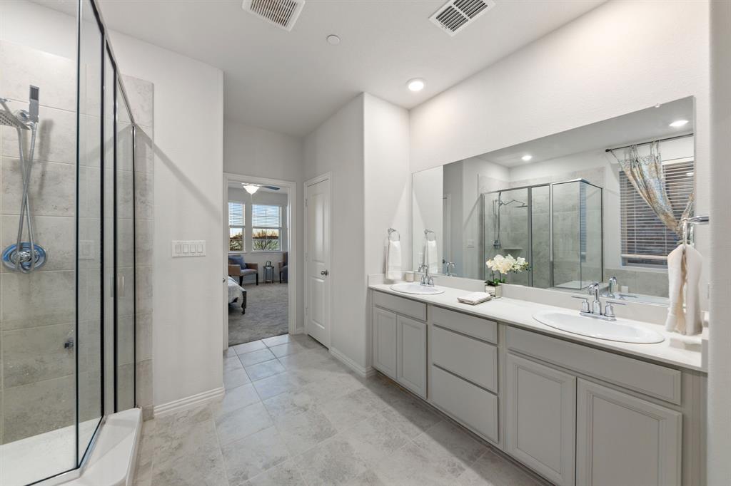 7505 Sunset Boulevard Rowlett, TX 75088 - Photo 18 of 33 a bathroom with a double vanity sink mirror and shower