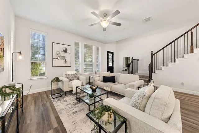 a living room with furniture and wooden floor