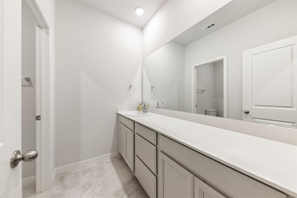 7505 Sunset Boulevard Rowlett, TX 75088 - Photo 21 of 33 a bathroom with a sink and a mirror