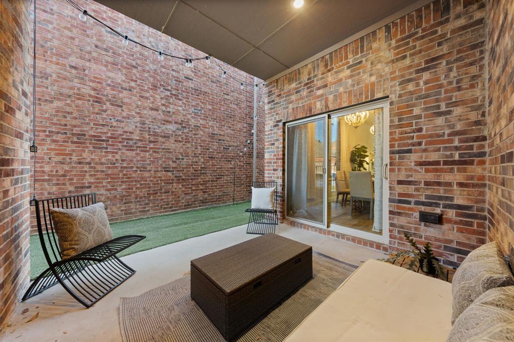 7505 Sunset Boulevard Rowlett, TX 75088 - Photo 24 of 33 a view of a patio with couches and a floor to ceiling window