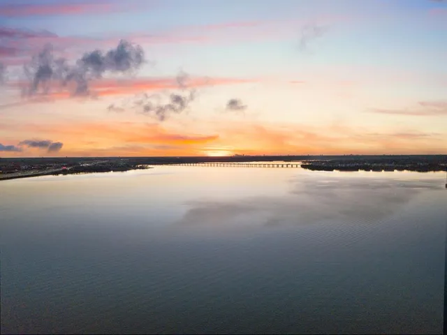 an aerial view of a house with ocean view