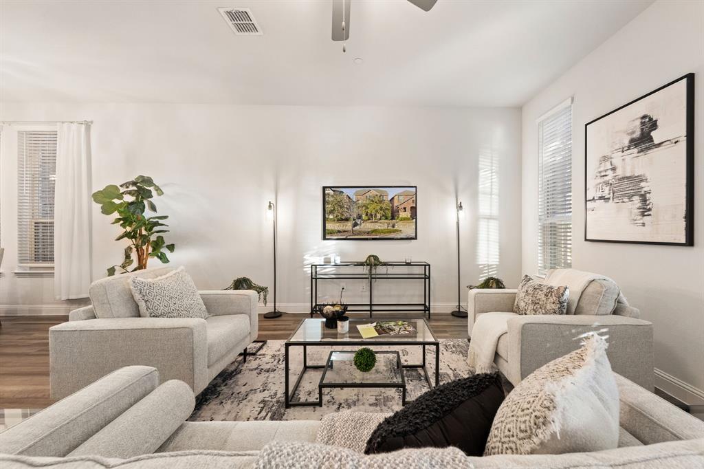7505 Sunset Boulevard Rowlett, TX 75088 - Photo 3 of 33 a living room with furniture or couch and a potted plant