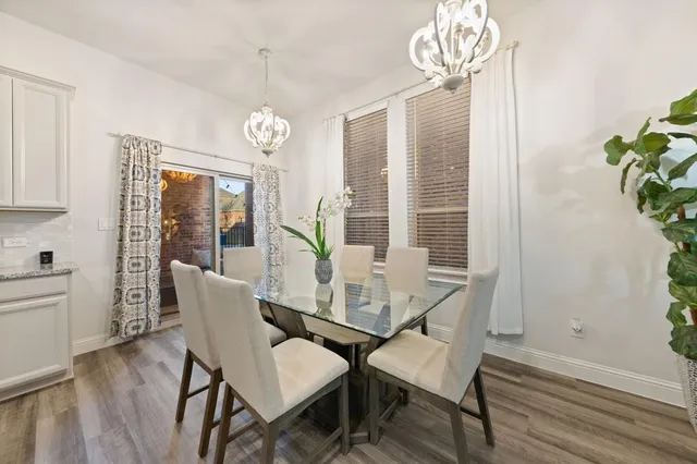 a view of a dining room with furniture wooden floor and chandelier
