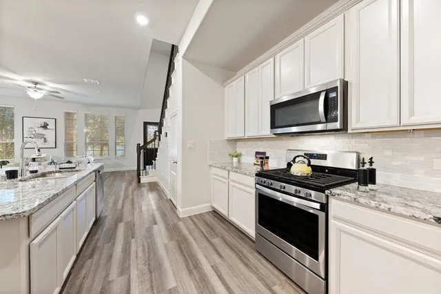a kitchen with a sink stove and microwave