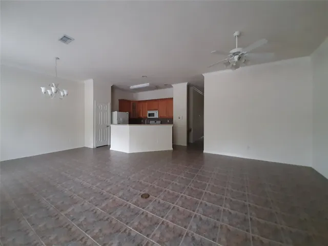 a view of a kitchen with a sink and a refrigerator
