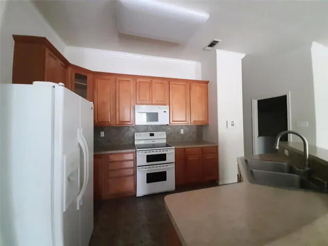 a kitchen with stainless steel appliances a refrigerator and a stove
