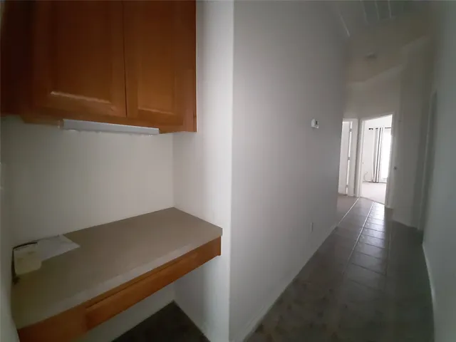a view of storage and utility room with wooden floor