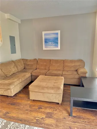 a living room with couches and kitchen view