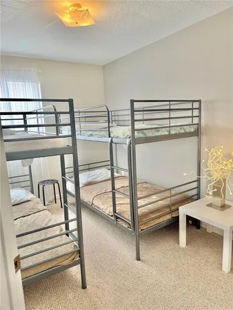 a bedroom with two beds and a chandelier