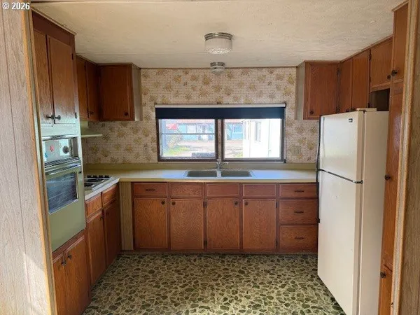 a kitchen with granite countertop cabinets and appliances