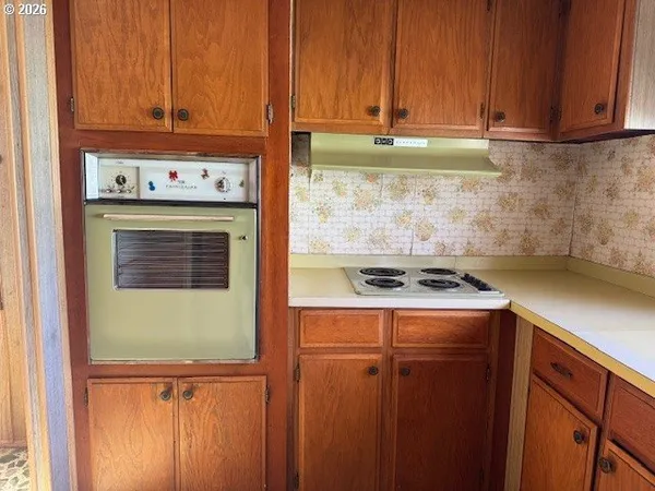 a kitchen with a refrigerator and cabinets