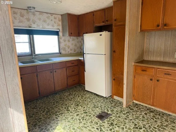 a view of a kitchen with a sink and a window
