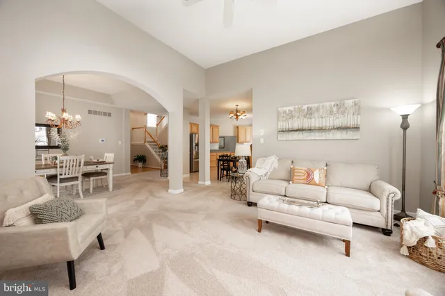 a kitchen with granite countertop stainless steel appliances a table and chairs in it