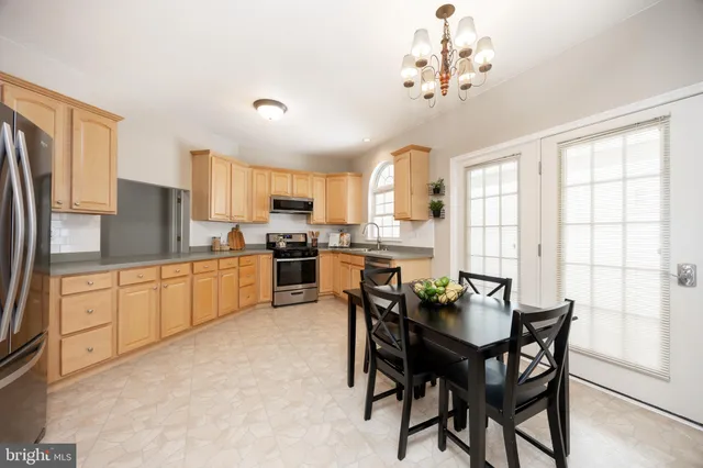 a kitchen with granite countertop a stove top oven sink and cabinets