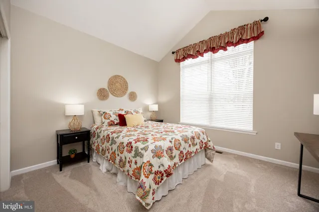 a bedroom with a bed and a lamp