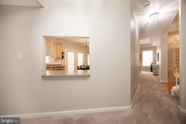 a bedroom with a bed a dresser and window