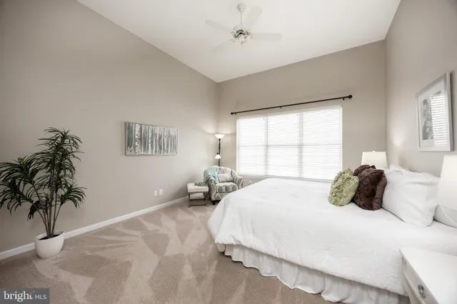 a bedroom with a bed and a lamp