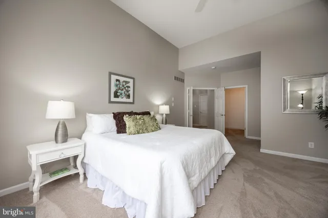 a bedroom with a bed and a large window