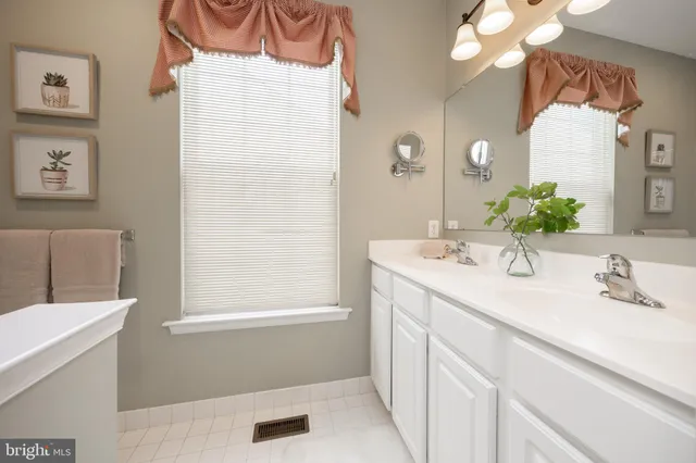 a white toilet sitting next to a bathroom sink