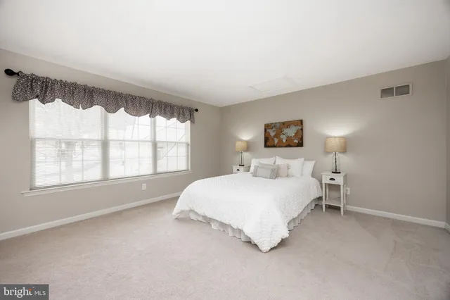 a bedroom with a bed and a tv