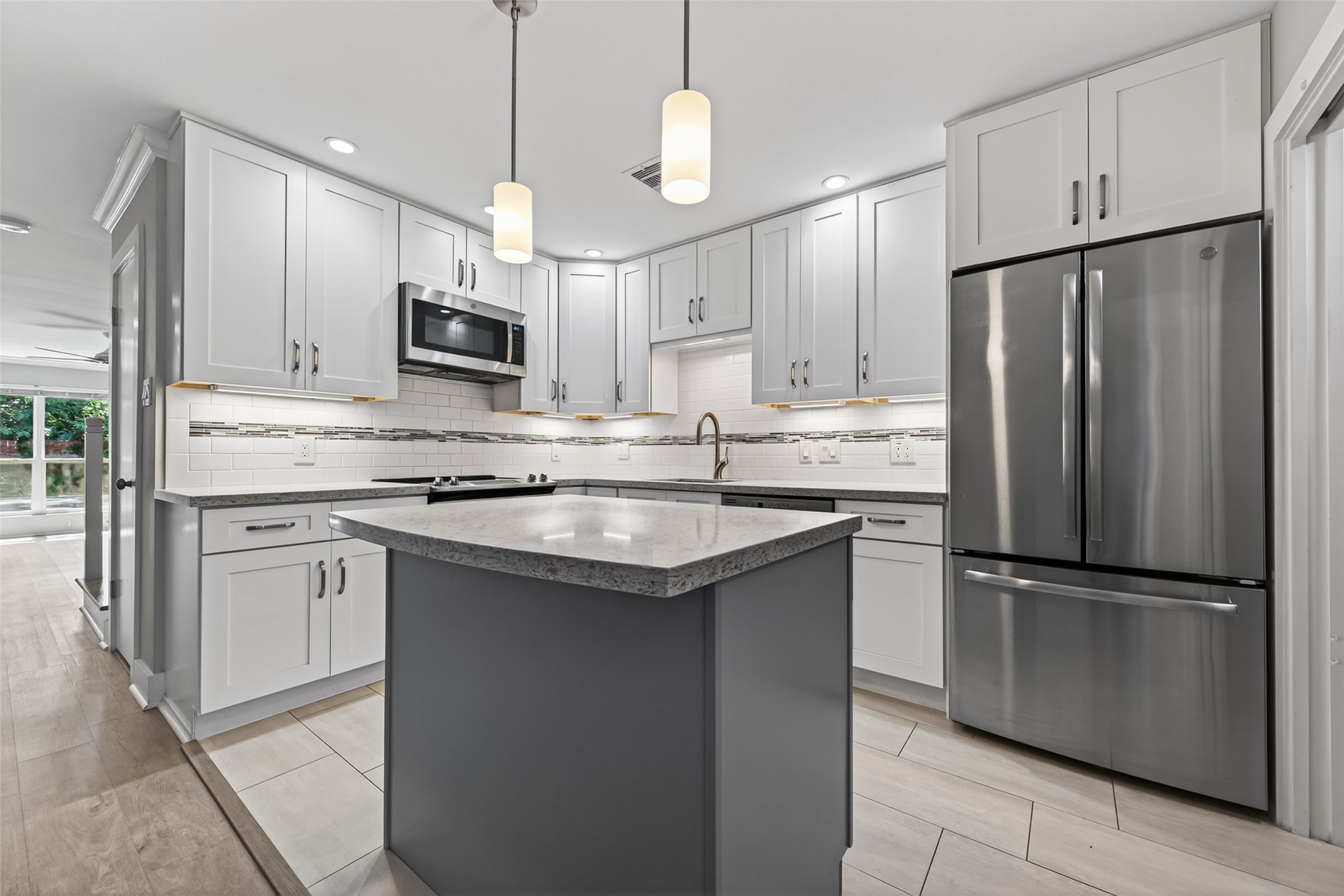 1805 Witte Road, Unit 3 Houston, TX 77080 - Photo 11 of 33 a kitchen with kitchen island granite countertop stainless steel appliances and refrigerator