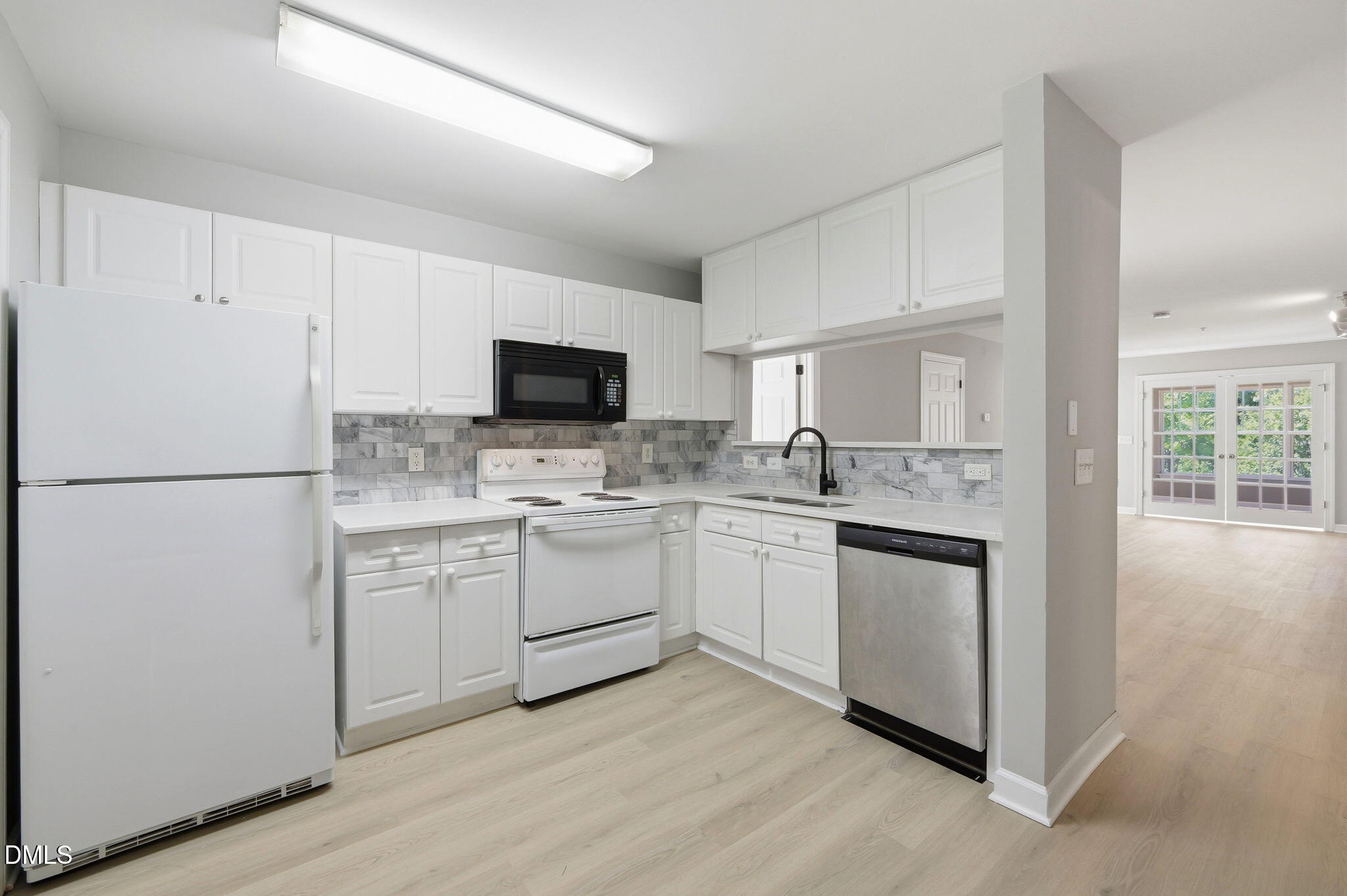 929 Morreene Road, Unit A23 Durham, NC 27705 - Photo 4 of 41 a kitchen with white cabinets and white appliances