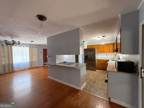 a kitchen with a sink cabinets and wooden floor