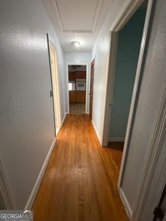 a view of a hallway with wooden floor