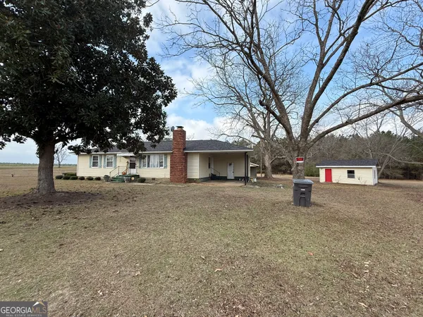 a view of a house with a yard and garage