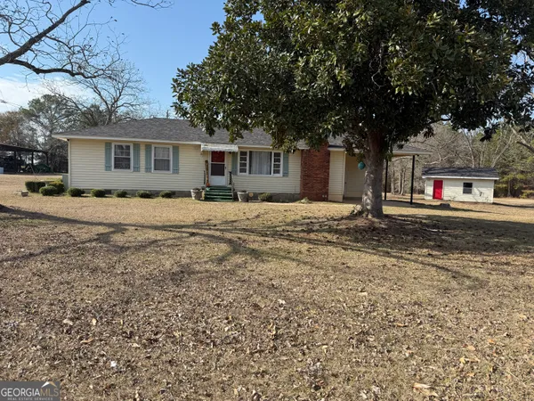 a house that has a tree in front of it