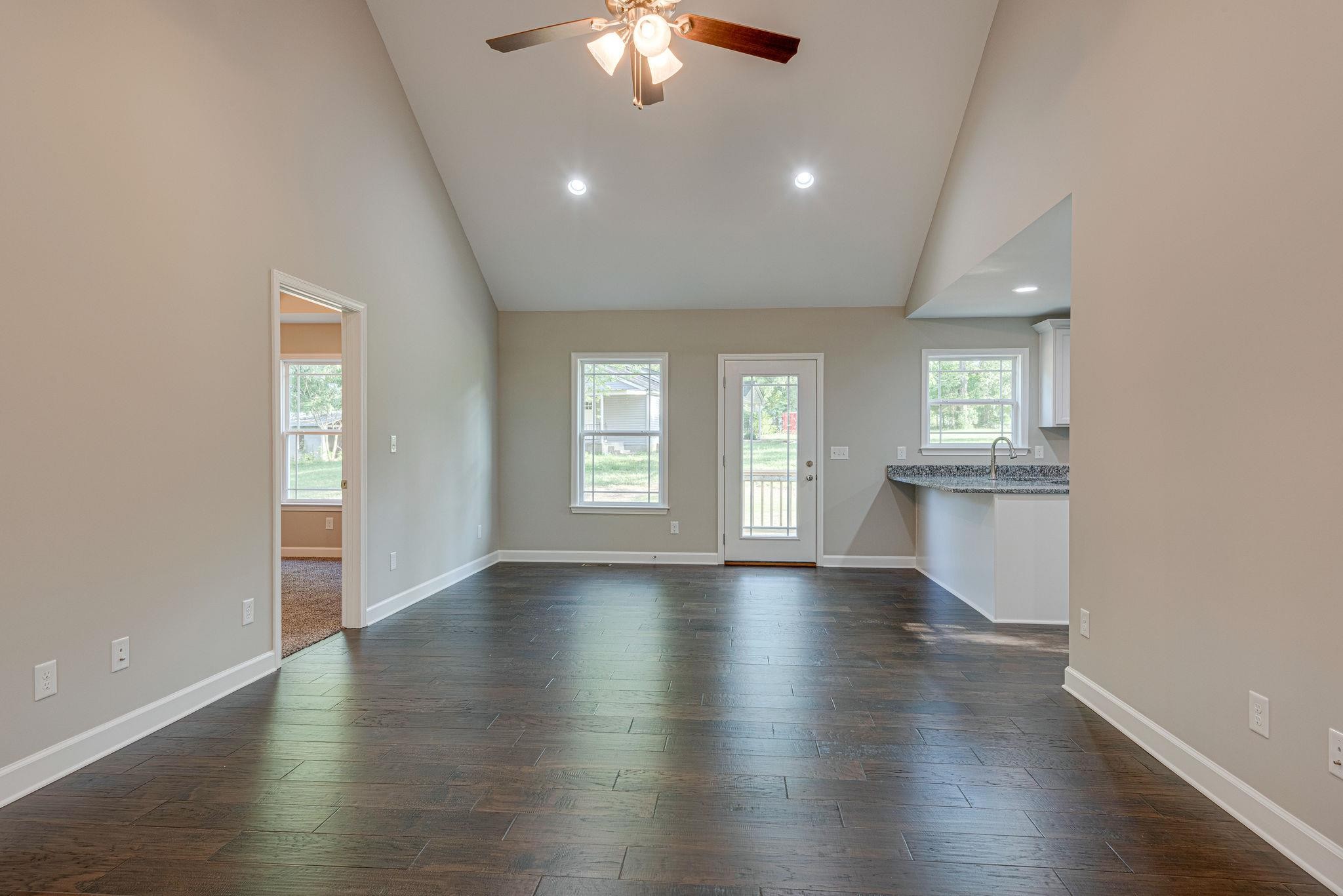 400 Kaiser Road Dickson, TN 37055 - Photo 3 of 11 an empty room with wooden floor chandelier and windows