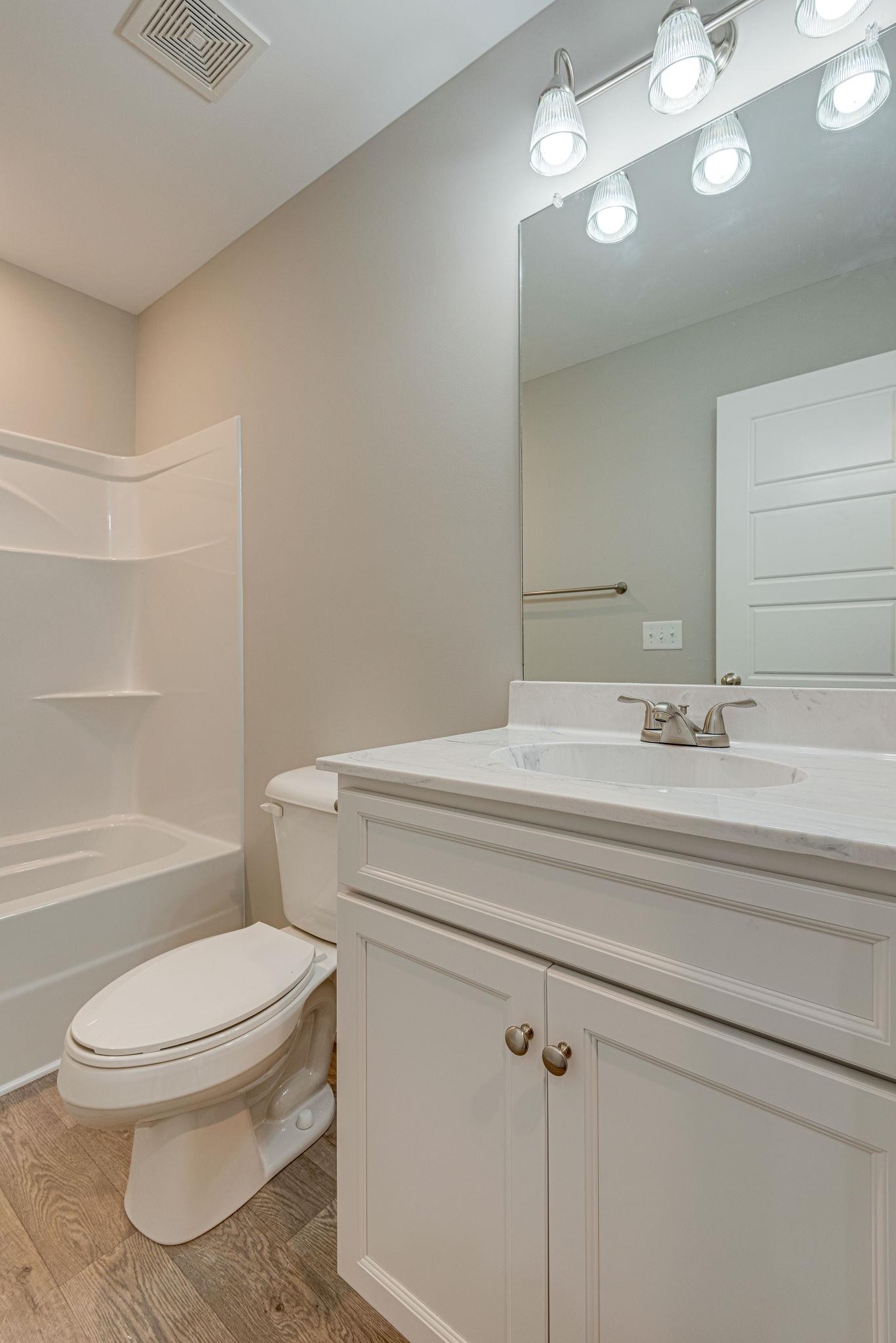400 Kaiser Road Dickson, TN 37055 - Photo 10 of 11 a bathroom with a toilet a sink and bathtub