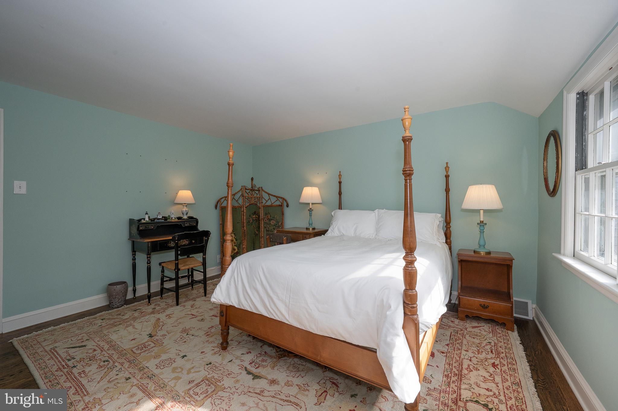 510 Lynmere Road Bryn Mawr, PA 19010 - Photo 31 of 44 a bedroom with a bed table and two windows