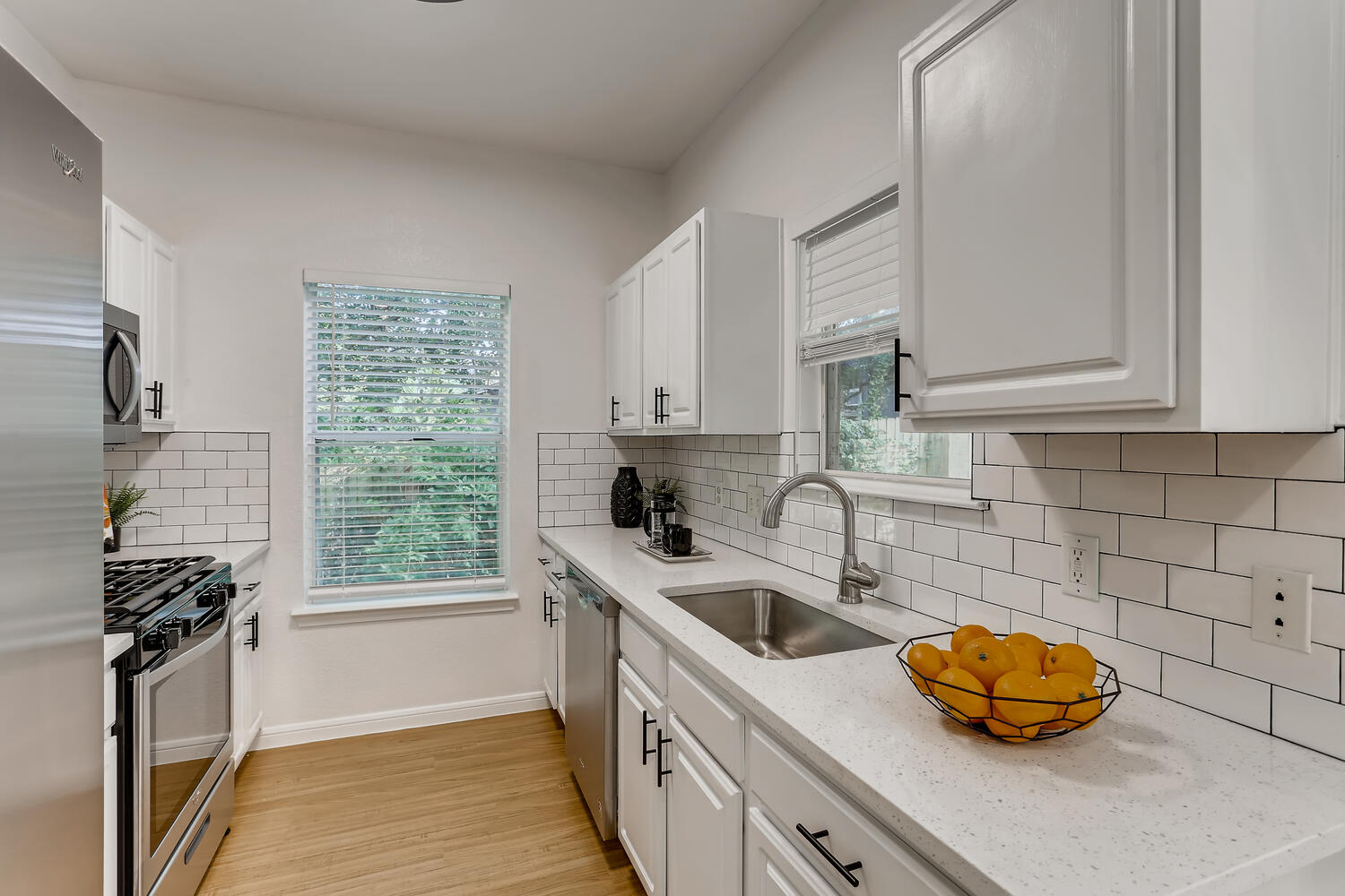 1206 Maple Avenue Austin, TX 78702 - Photo 2 of 39 a kitchen with stainless steel appliances a sink a stove and a window