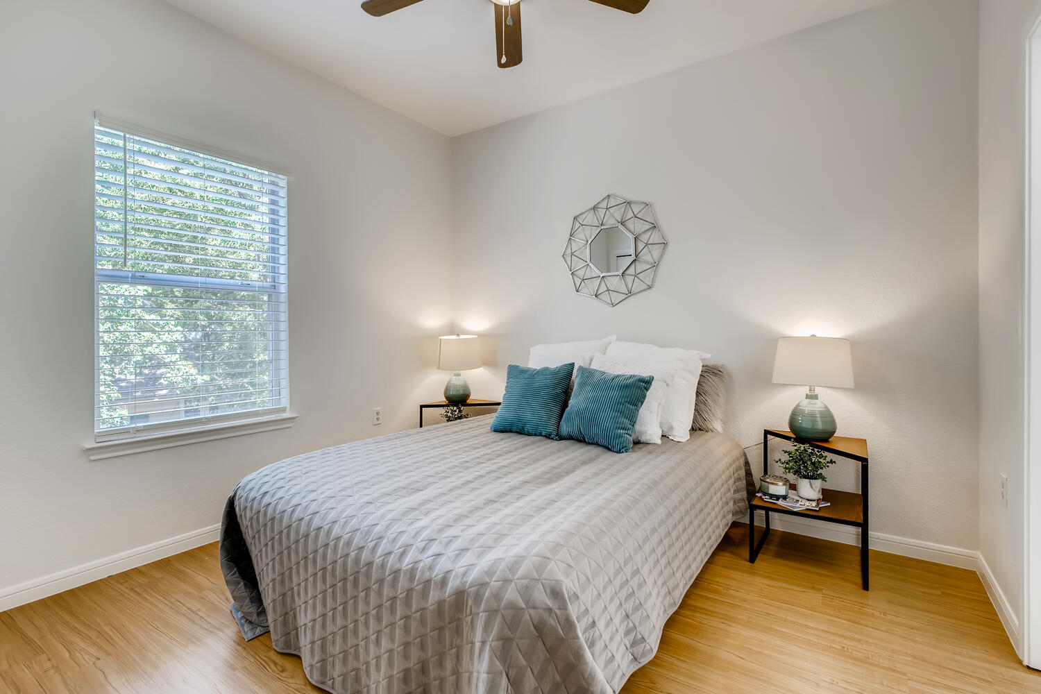 1206 Maple Avenue Austin, TX 78702 - Photo 34 of 39 a bedroom with a bed and wooden floor