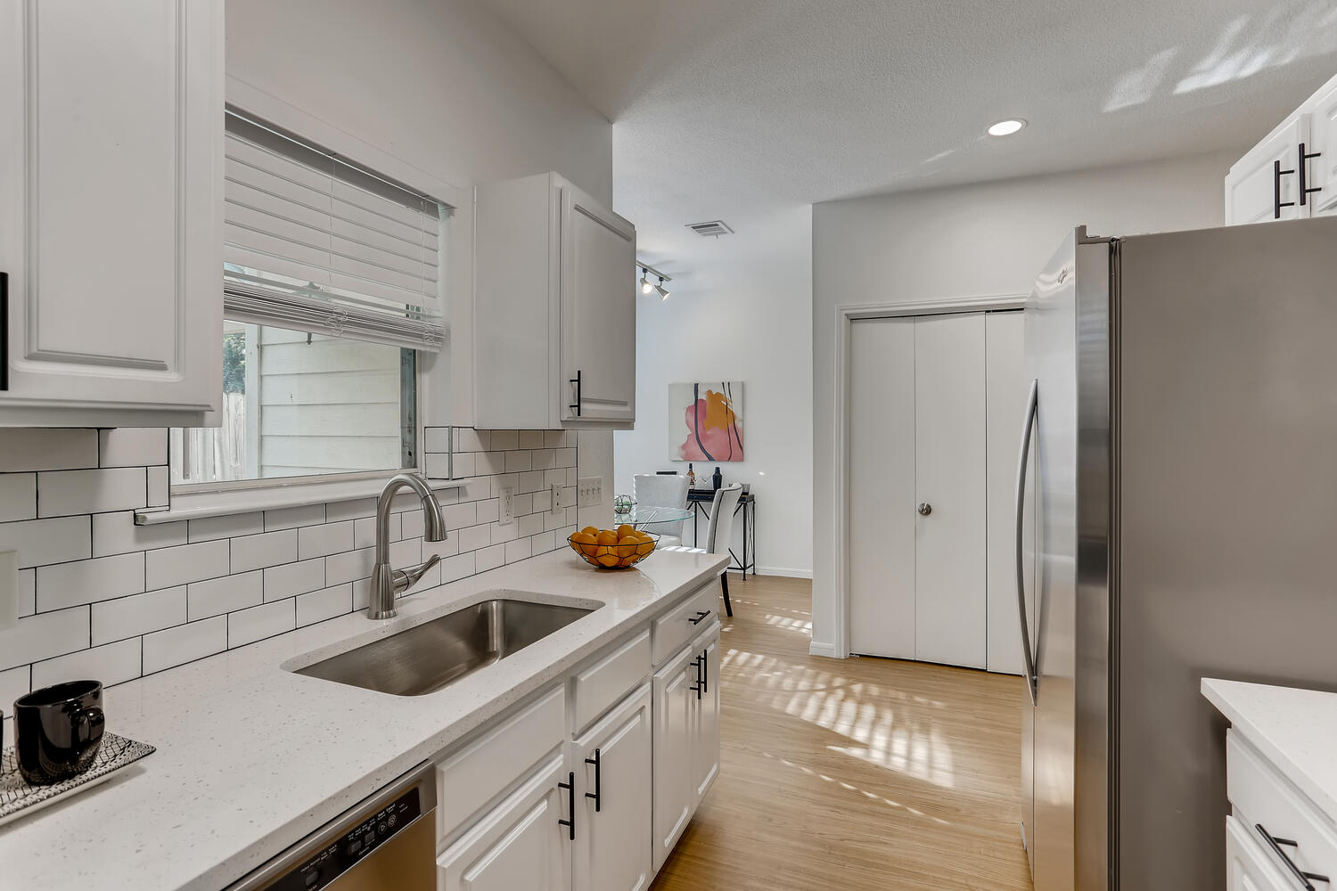 1206 Maple Avenue Austin, TX 78702 - Photo 7 of 39 a kitchen with a sink a refrigerator and cabinets