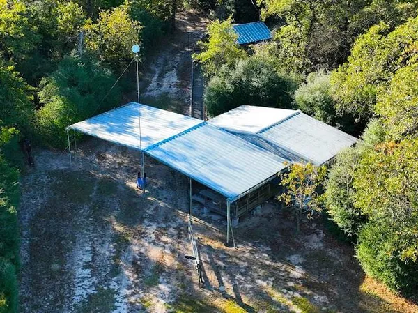 a aerial view of a house with a yard and lake view