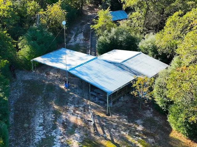 a aerial view of a house with a yard and lake view