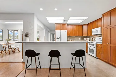 a kitchen with stainless steel appliances granite countertop a refrigerator sink and cabinets